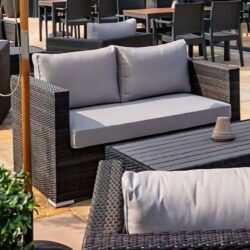 Arlo Rattan Outdoor 2 Seater Sofa With Light Grey Cushions In Brown